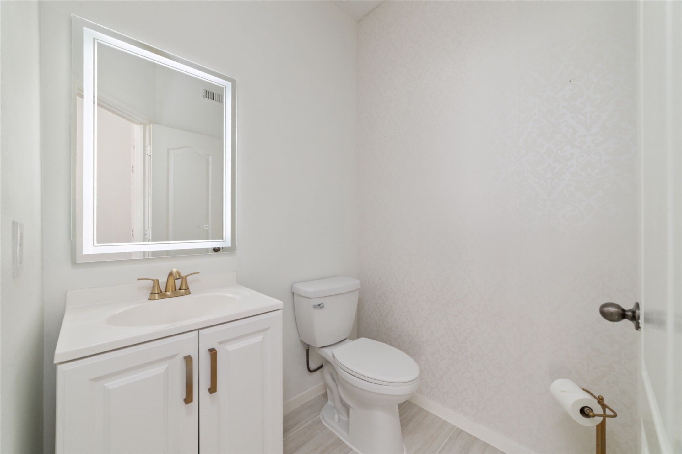 2618 Bridgestone Park Lane Spring, TX 77386 - Photo 23 of 49 The powder bath to the right of the living room features modern updates like this beauty mirror and modern hardware.