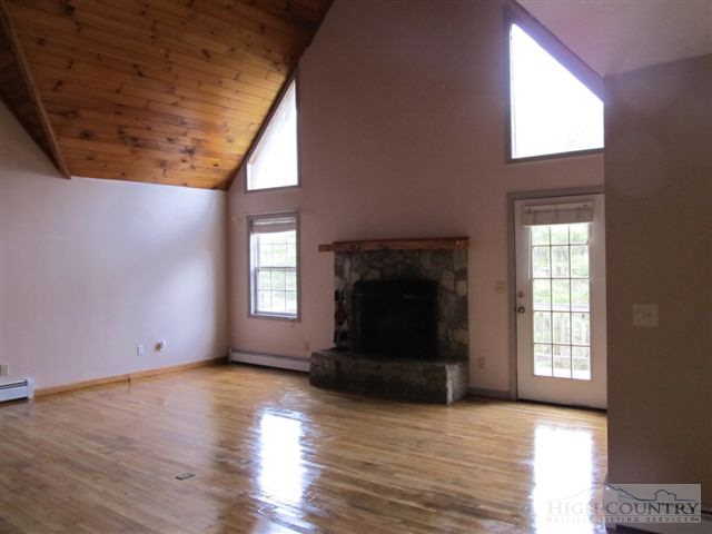 3192 Wildcat Road Deep Gap, NC 28618 - Photo 13 of 24 a view of empty room with wooden floor and fireplace