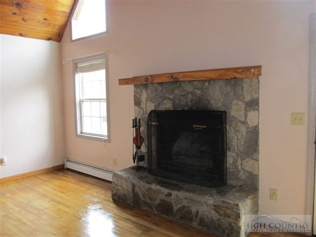 3192 Wildcat Road Deep Gap, NC 28618 - Photo 18 of 24 a living room with a fireplace in it