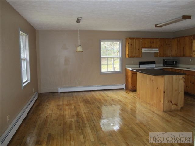 3192 Wildcat Road Deep Gap, NC 28618 - Photo 20 of 24 a view of a kitchen with a sink wooden floor and a window
