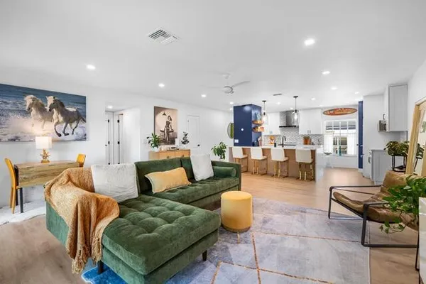 a living room with furniture and kitchen view