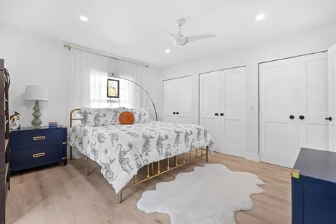 a bedroom with a bed and a night stand