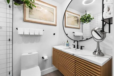 a bathroom with a sink a mirror and a toilet