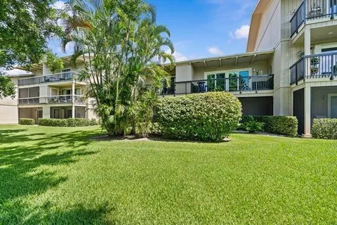 a front view of a building with a garden