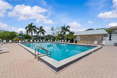 a view of swimming pool with a lounge chair