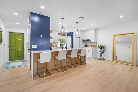 a large kitchen with a table and chairs