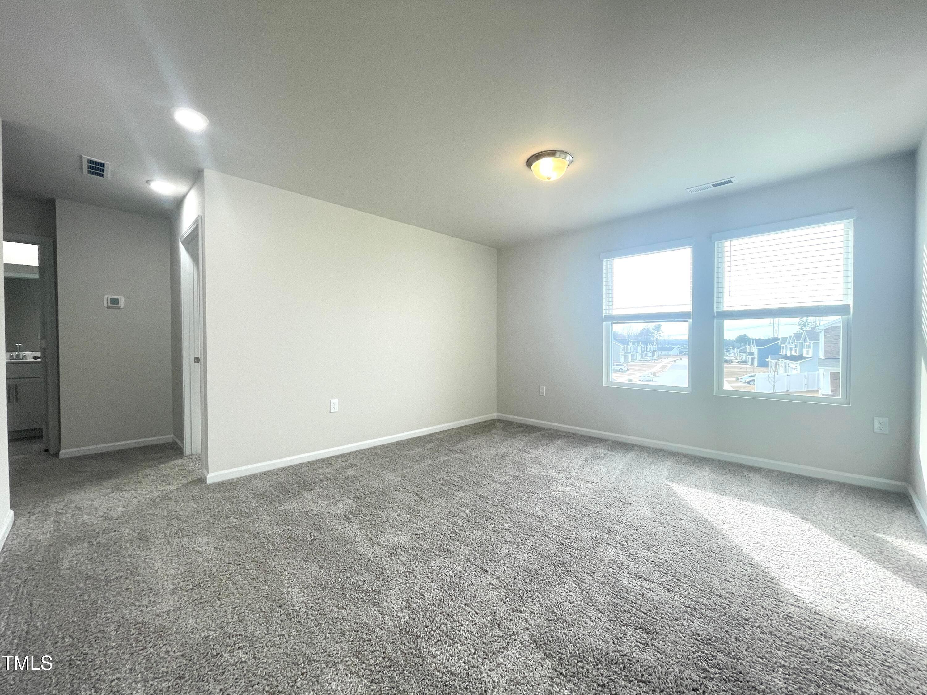 119 Red Valor Street Garner, NC 27529 - Photo 12 of 27 an empty room with windows