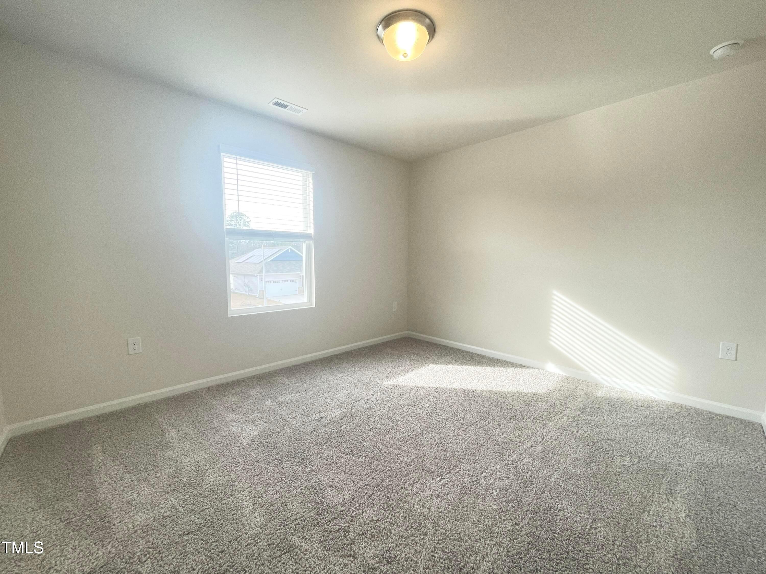 119 Red Valor Street Garner, NC 27529 - Photo 13 of 27 an empty room with windows