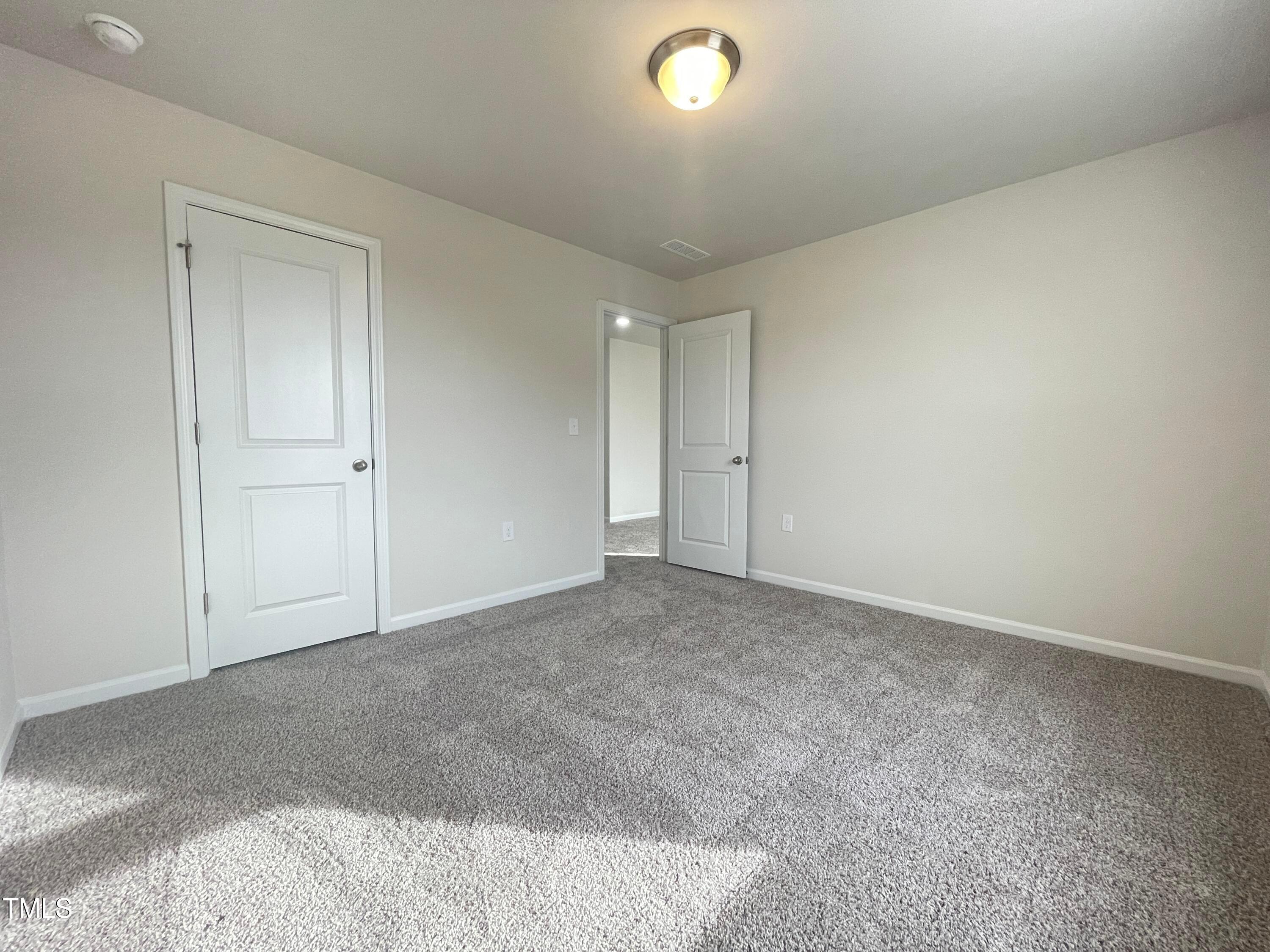 119 Red Valor Street Garner, NC 27529 - Photo 14 of 27 a view of an empty room and chandelier fan