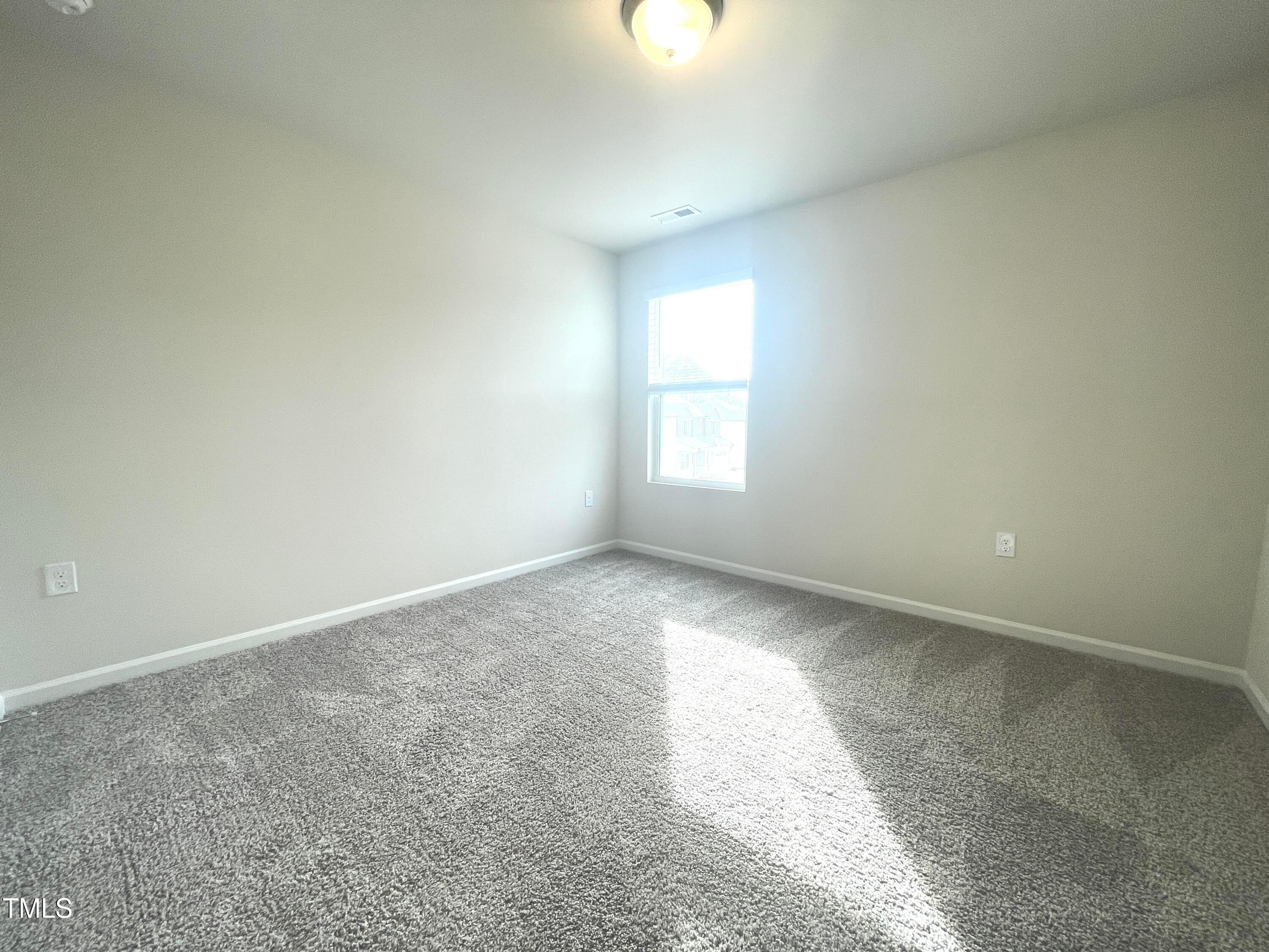 119 Red Valor Street Garner, NC 27529 - Photo 15 of 27 an empty room with windows