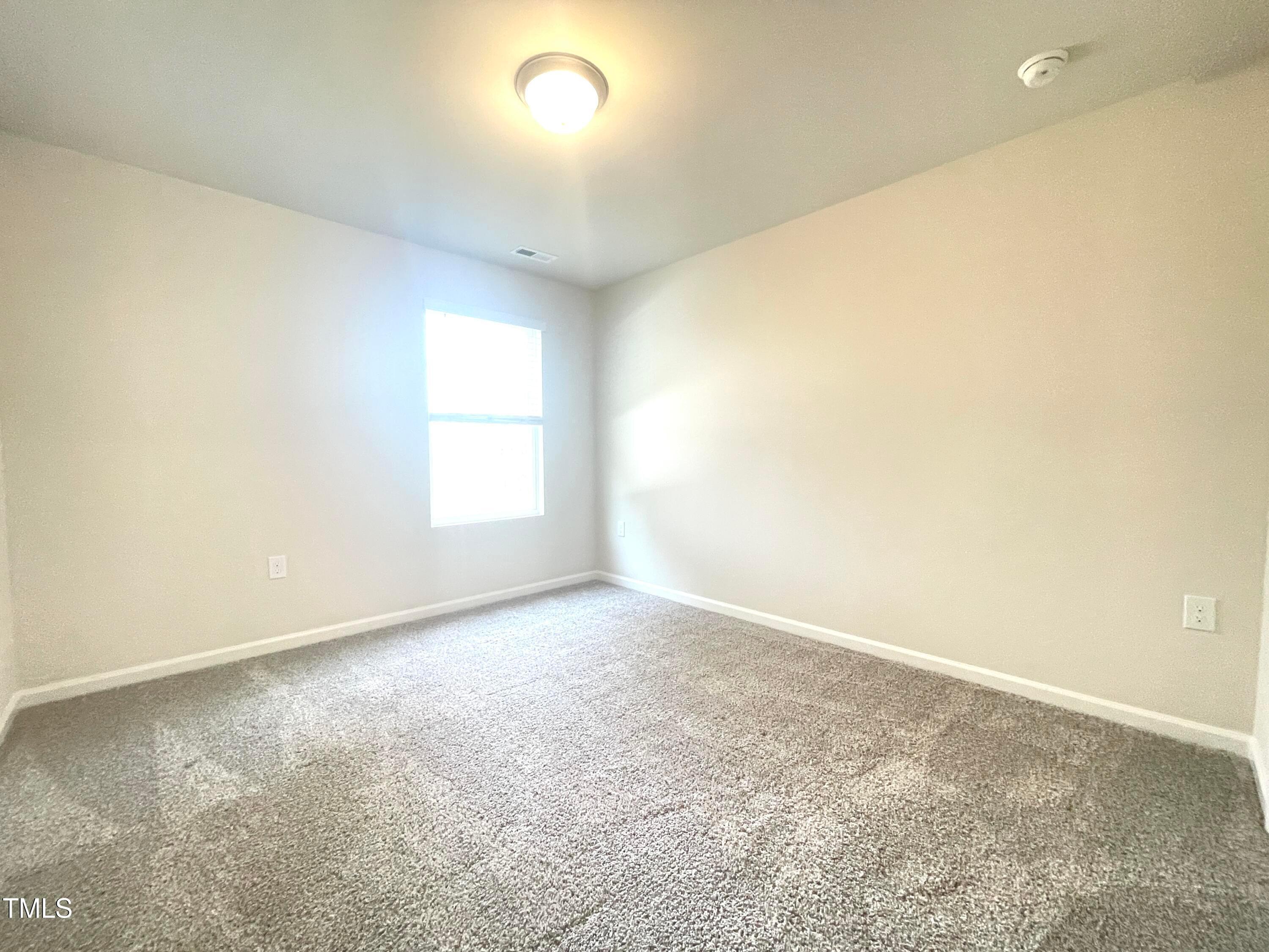 119 Red Valor Street Garner, NC 27529 - Photo 17 of 27 an empty room with a window