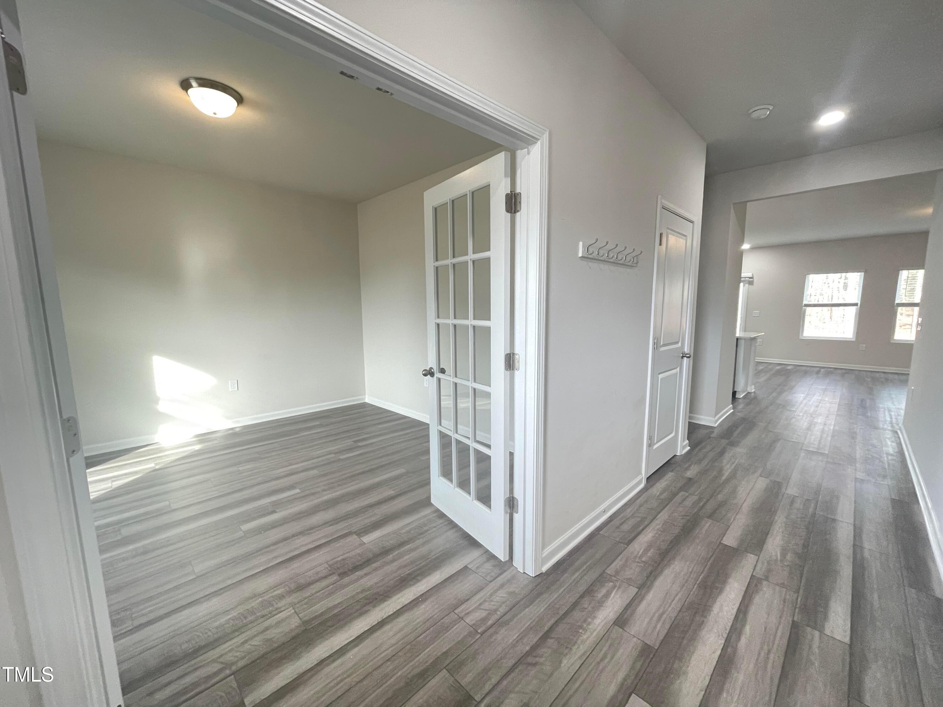 119 Red Valor Street Garner, NC 27529 - Photo 2 of 27 an empty room with wooden floor and windows
