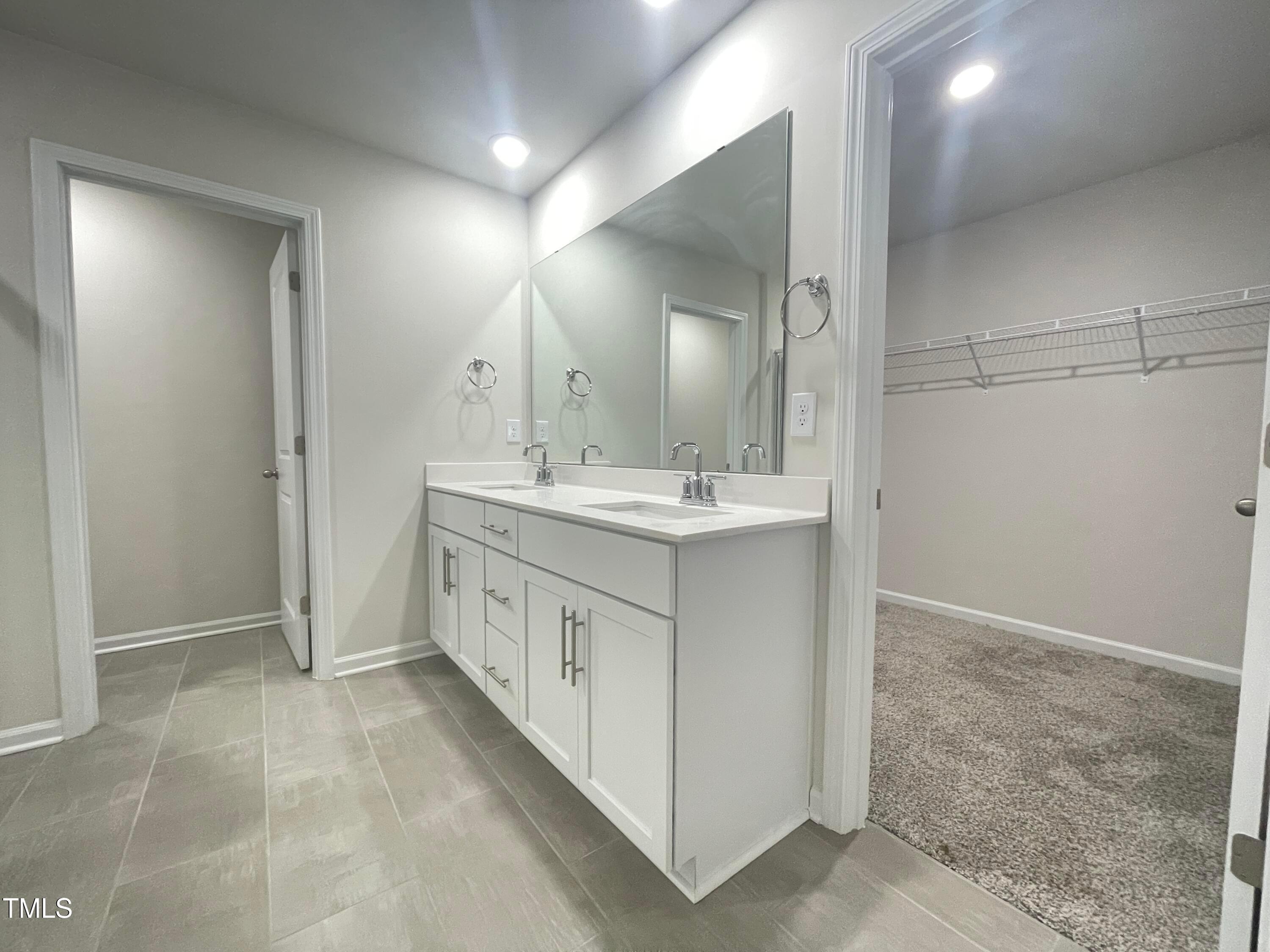 119 Red Valor Street Garner, NC 27529 - Photo 22 of 27 a bathroom with a double vanity sink and a mirror