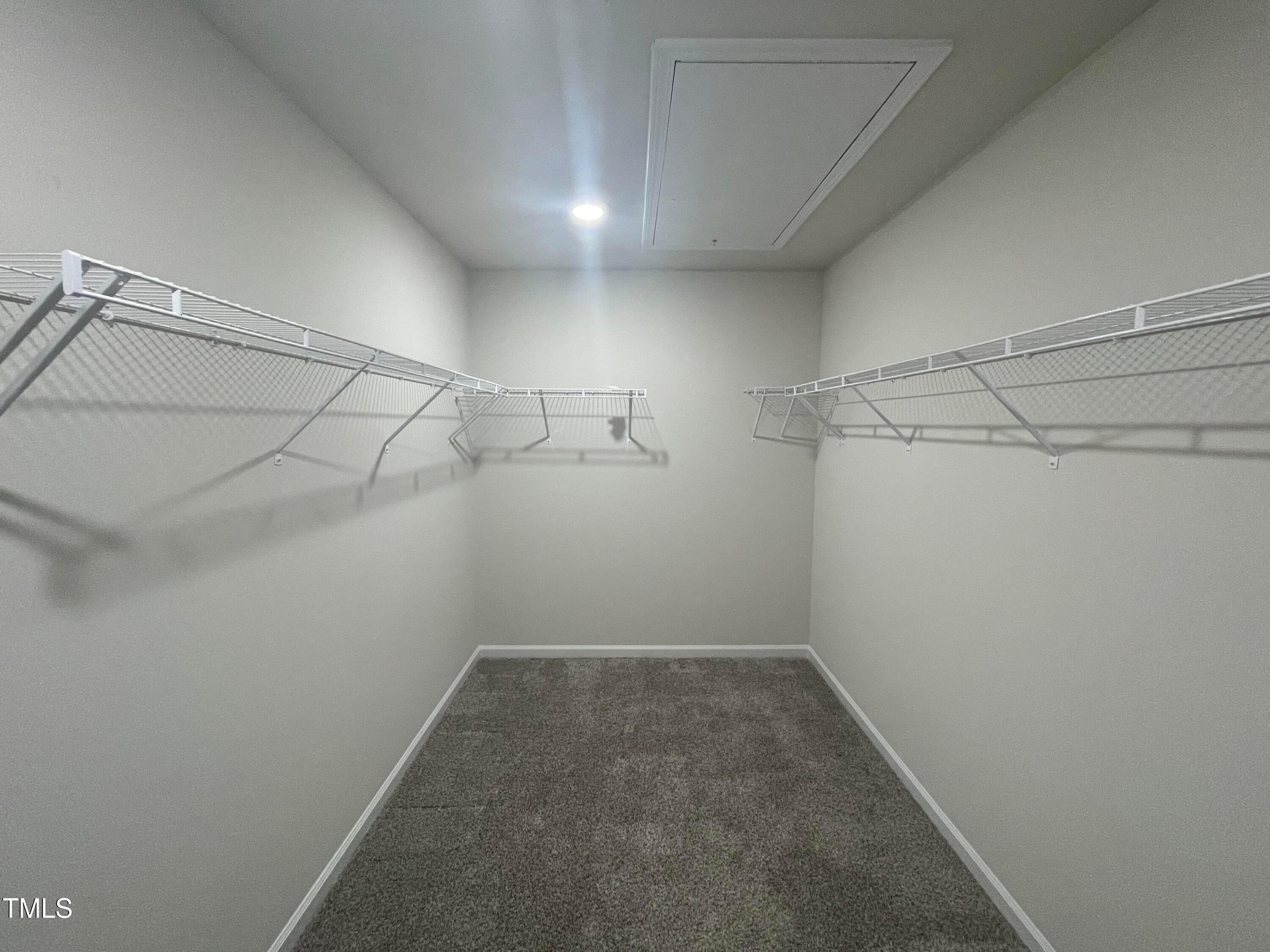 119 Red Valor Street Garner, NC 27529 - Photo 24 of 27 a view of a room with racks on the wall