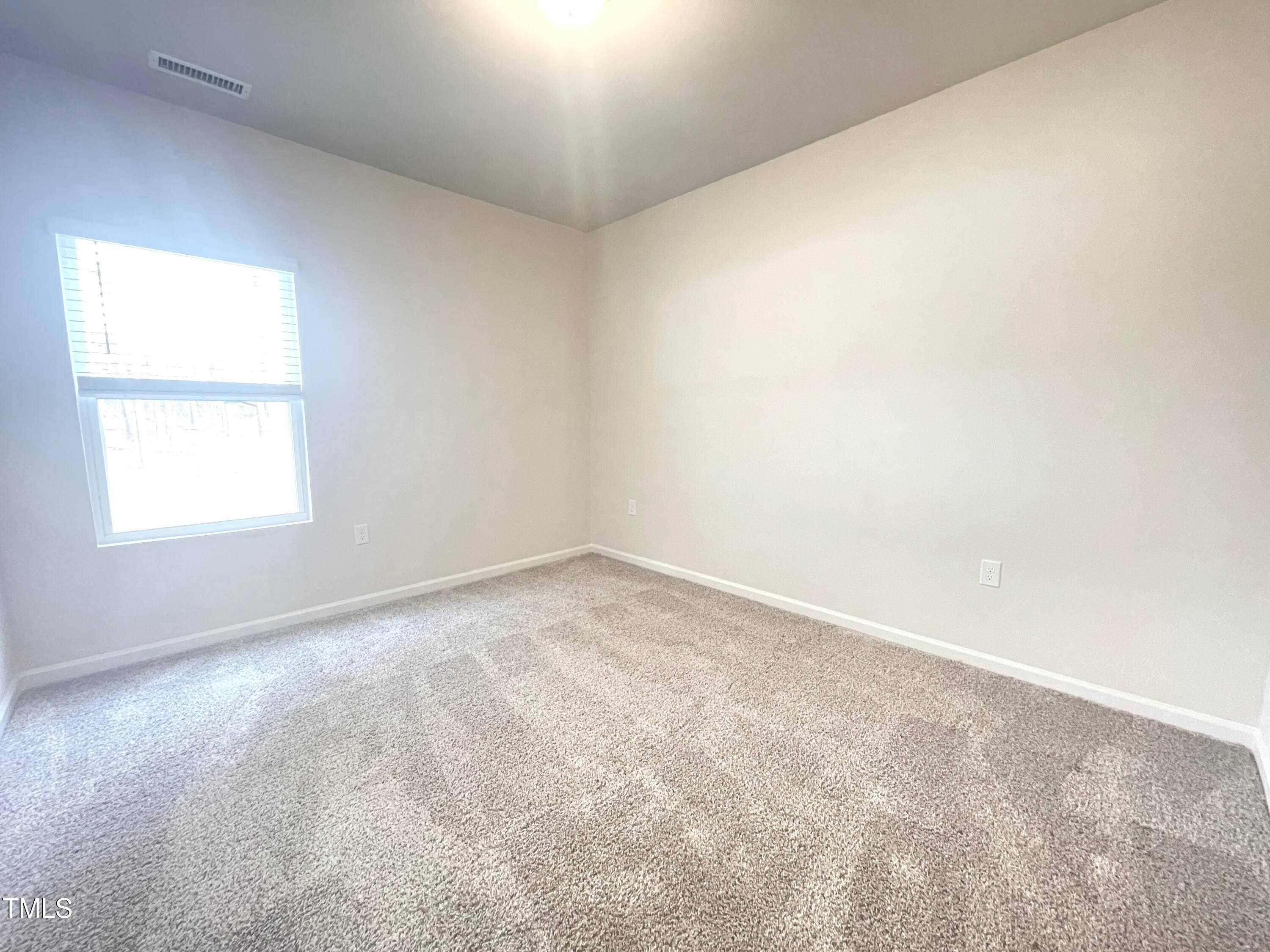 119 Red Valor Street Garner, NC 27529 - Photo 9 of 27 an empty room with a window