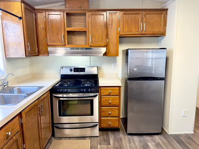 a kitchen with stainless steel appliances granite countertop a stove and a microwave