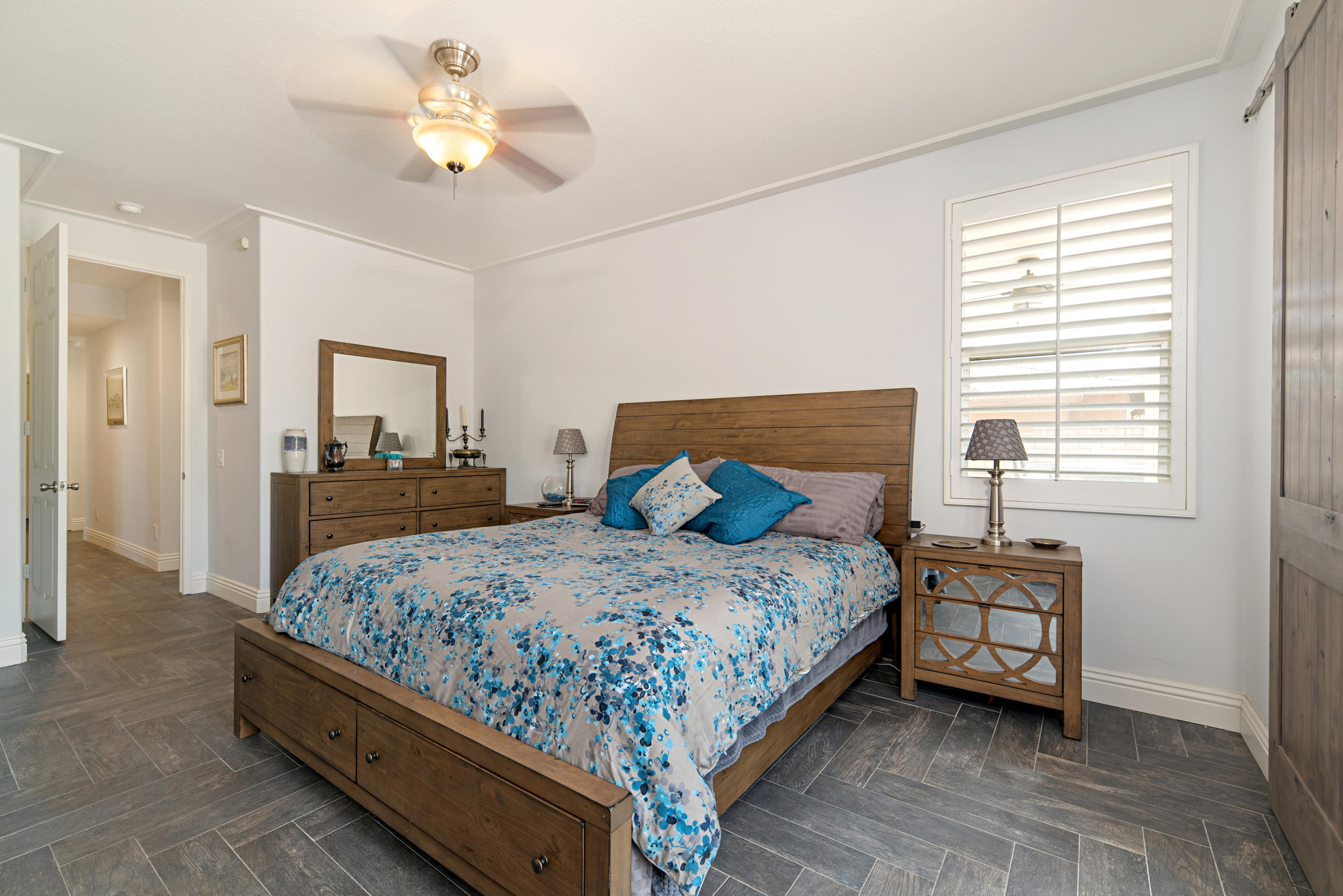 37431 Haweswater Road Indio, CA 92203 - Photo 14 of 41 a bedroom with a bed and a chandelier