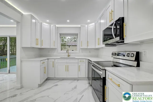 a kitchen with stainless steel appliances granite countertop a sink and a stove