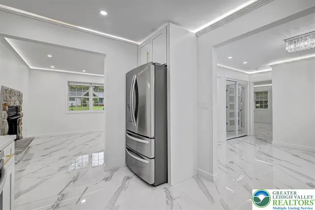 a kitchen with stainless steel appliances granite countertop a refrigerator and a stove top oven