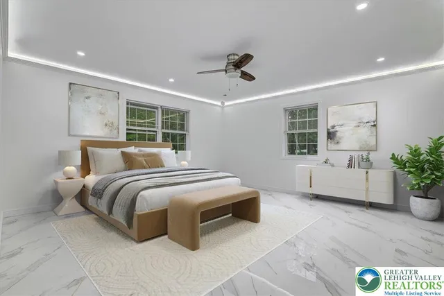 a bedroom with a large bed and a potted plant