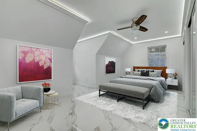 a spacious bedroom with a bed and furniture