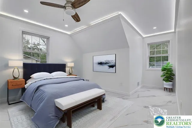 a bedroom with a bed and a potted plant