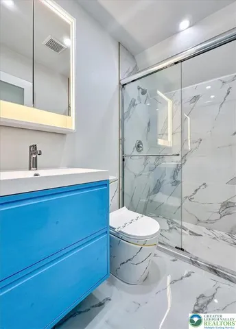 a bathroom with a sink toilet and shower
