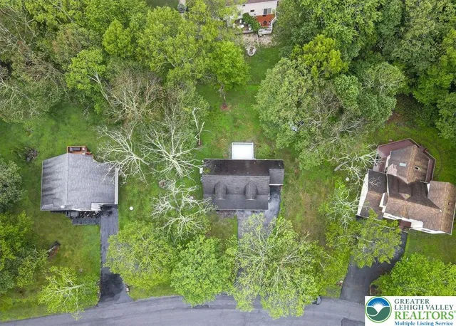 an aerial view of a house with outdoor space and street view
