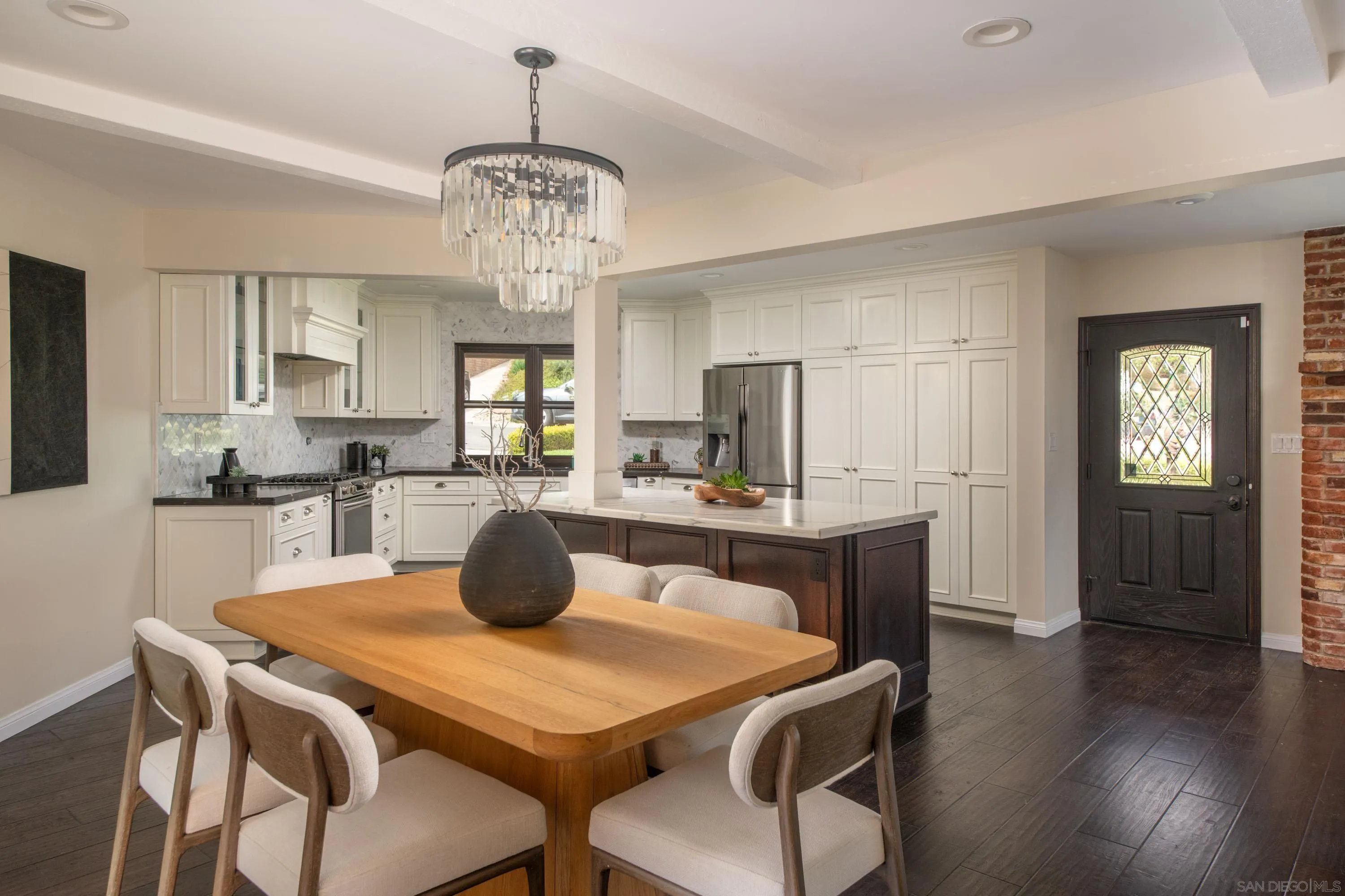 5602 Ladybird Lane La Jolla, CA 92037 - Photo 2 of 3 a kitchen with stainless steel appliances a dining table chairs and wooden floor