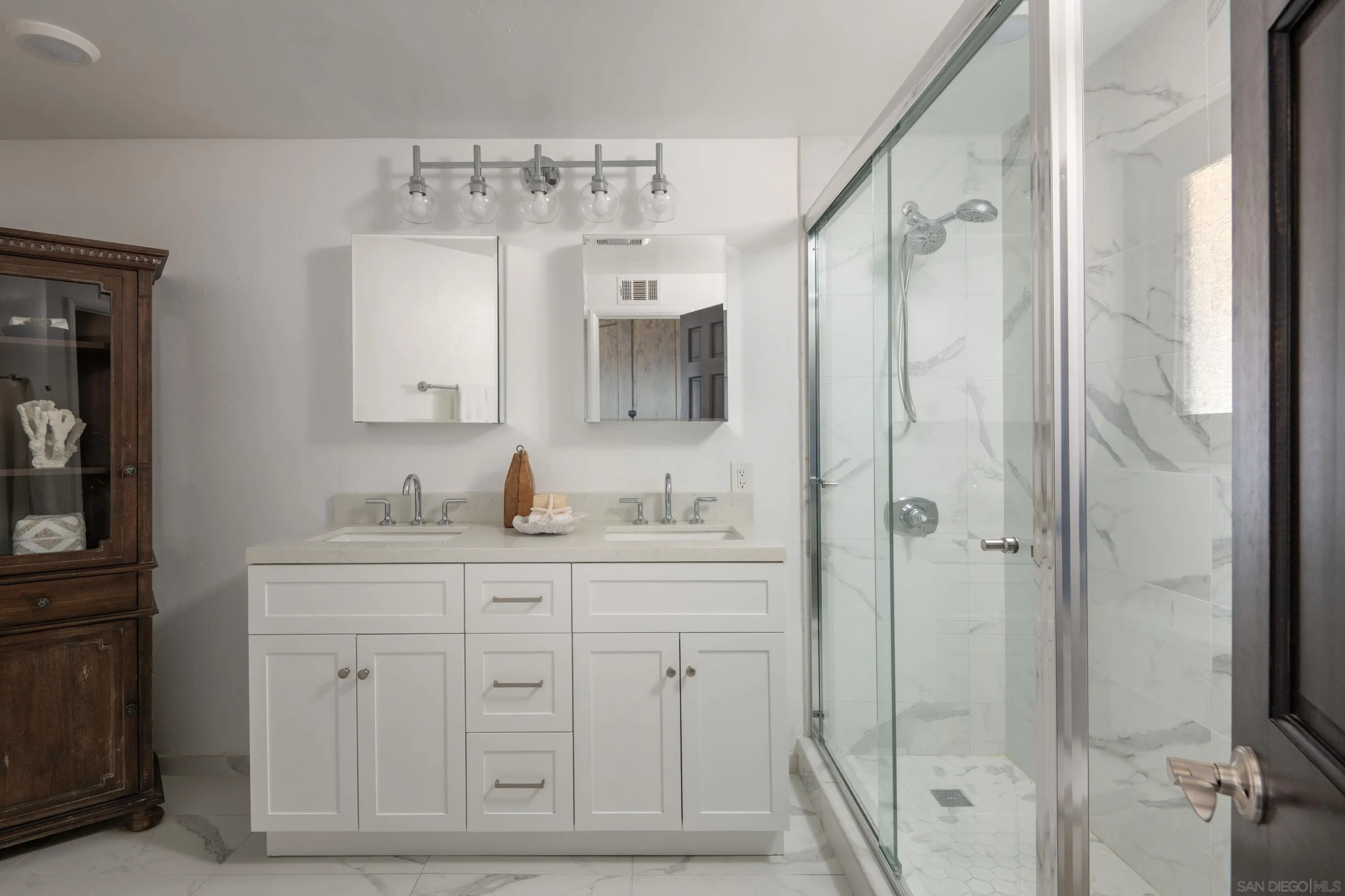 5602 Ladybird Lane La Jolla, CA 92037 - Photo 3 of 3 a bathroom with a double vanity sink mirror and