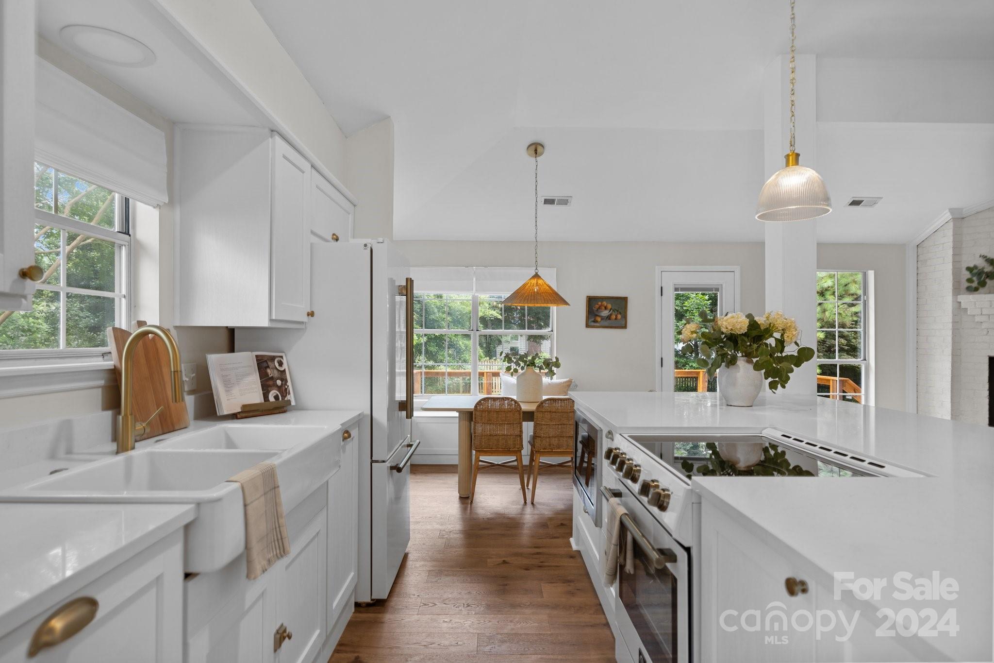 10527 Fairway Ridge Road Charlotte, NC 28277 - Photo 12 of 45 a kitchen that has a lot of cabinets in it and wooden floors
