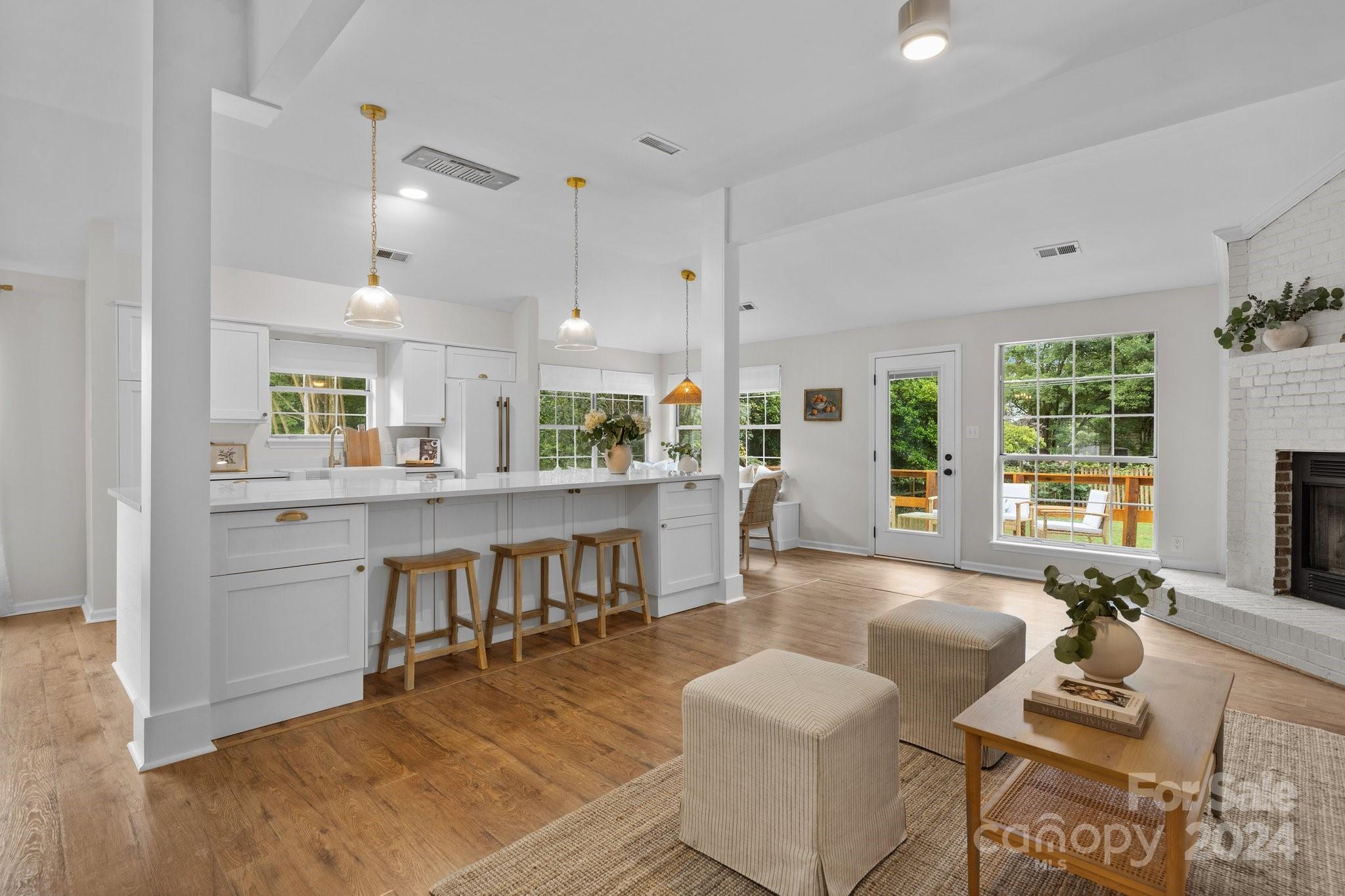 10527 Fairway Ridge Road Charlotte, NC 28277 - Photo 3 of 45 a living room with furniture a dining table and chairs with kitchen view