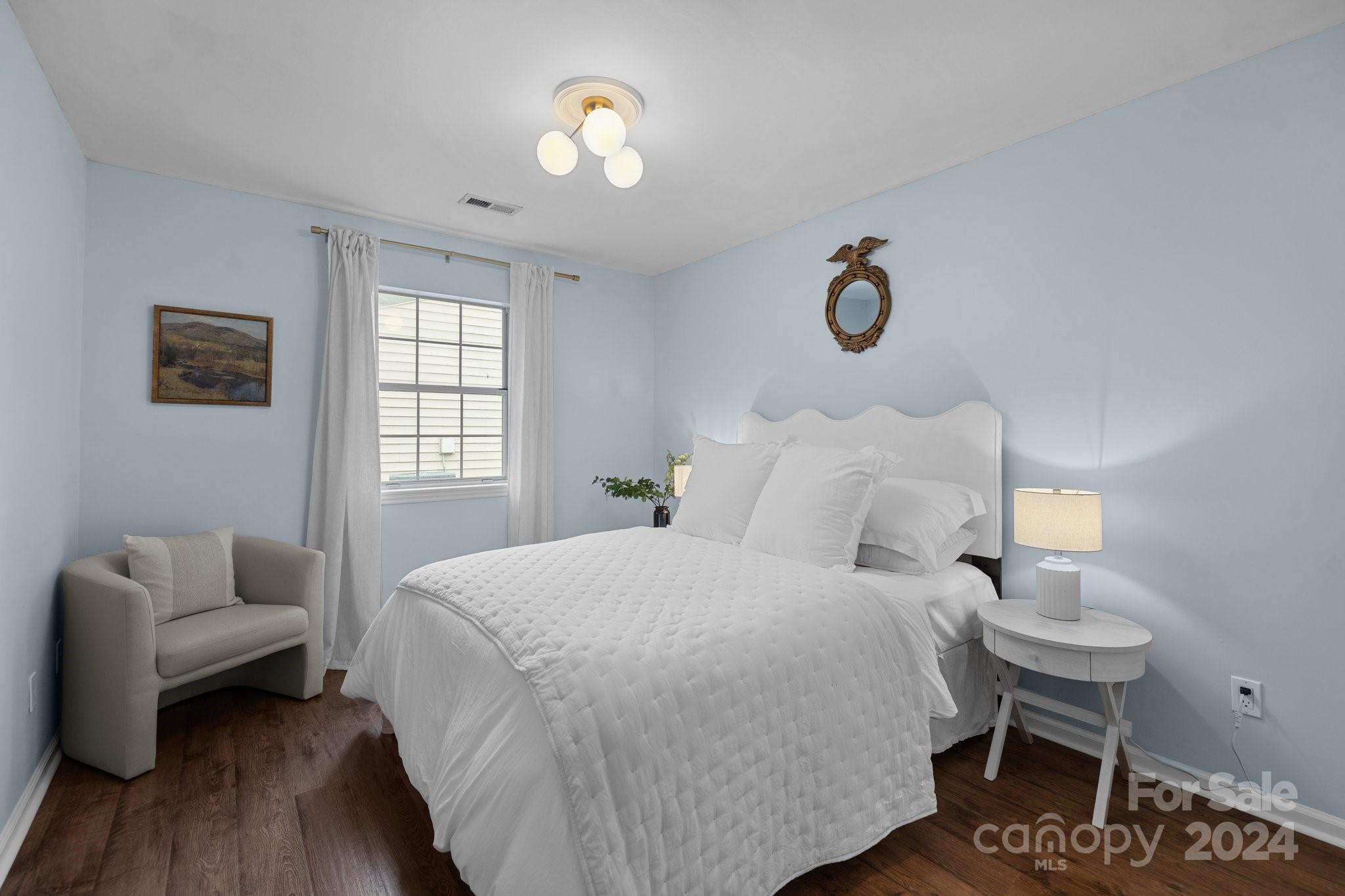 10527 Fairway Ridge Road Charlotte, NC 28277 - Photo 32 of 45 a bedroom with a bed and a chandelier