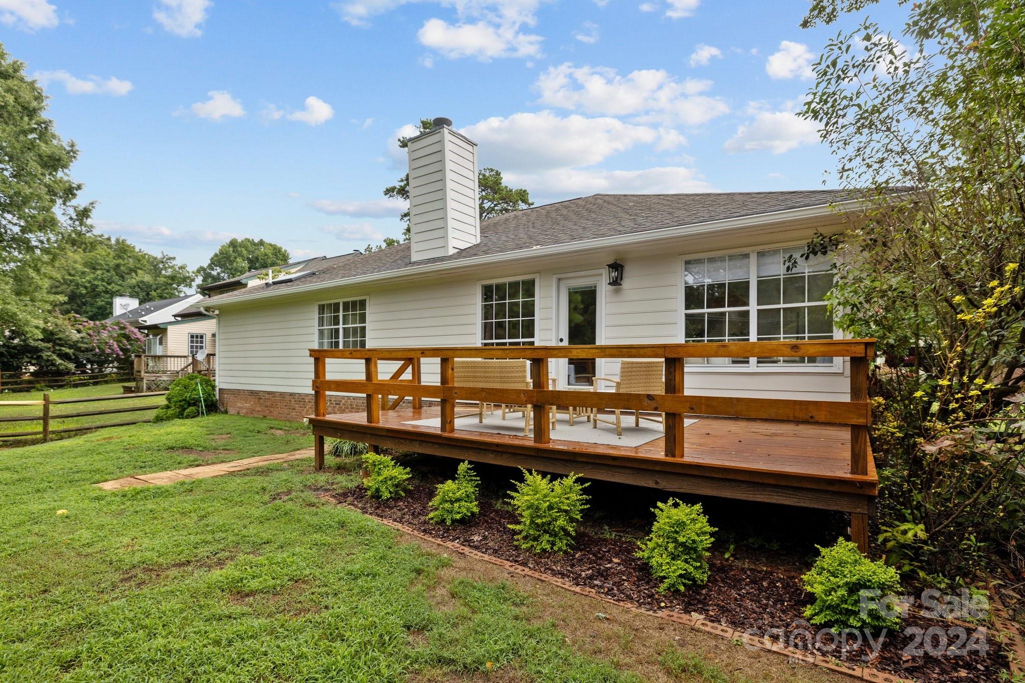 10527 Fairway Ridge Road Charlotte, NC 28277 - Photo 36 of 45 a front view of a house with a garden and sitting area