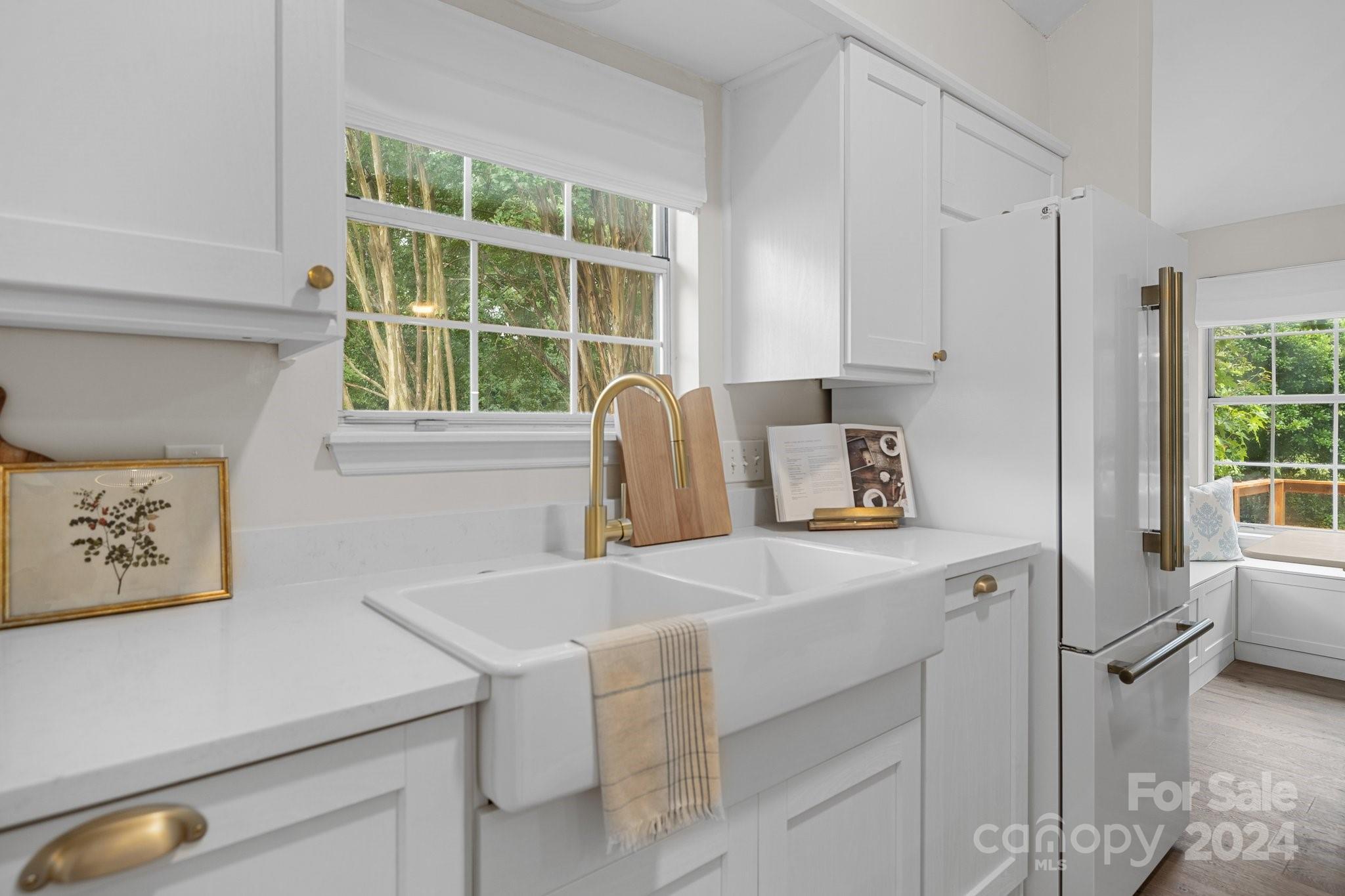 10527 Fairway Ridge Road Charlotte, NC 28277 - Photo 4 of 45 a white kitchen with a sink a stove and a refrigerator