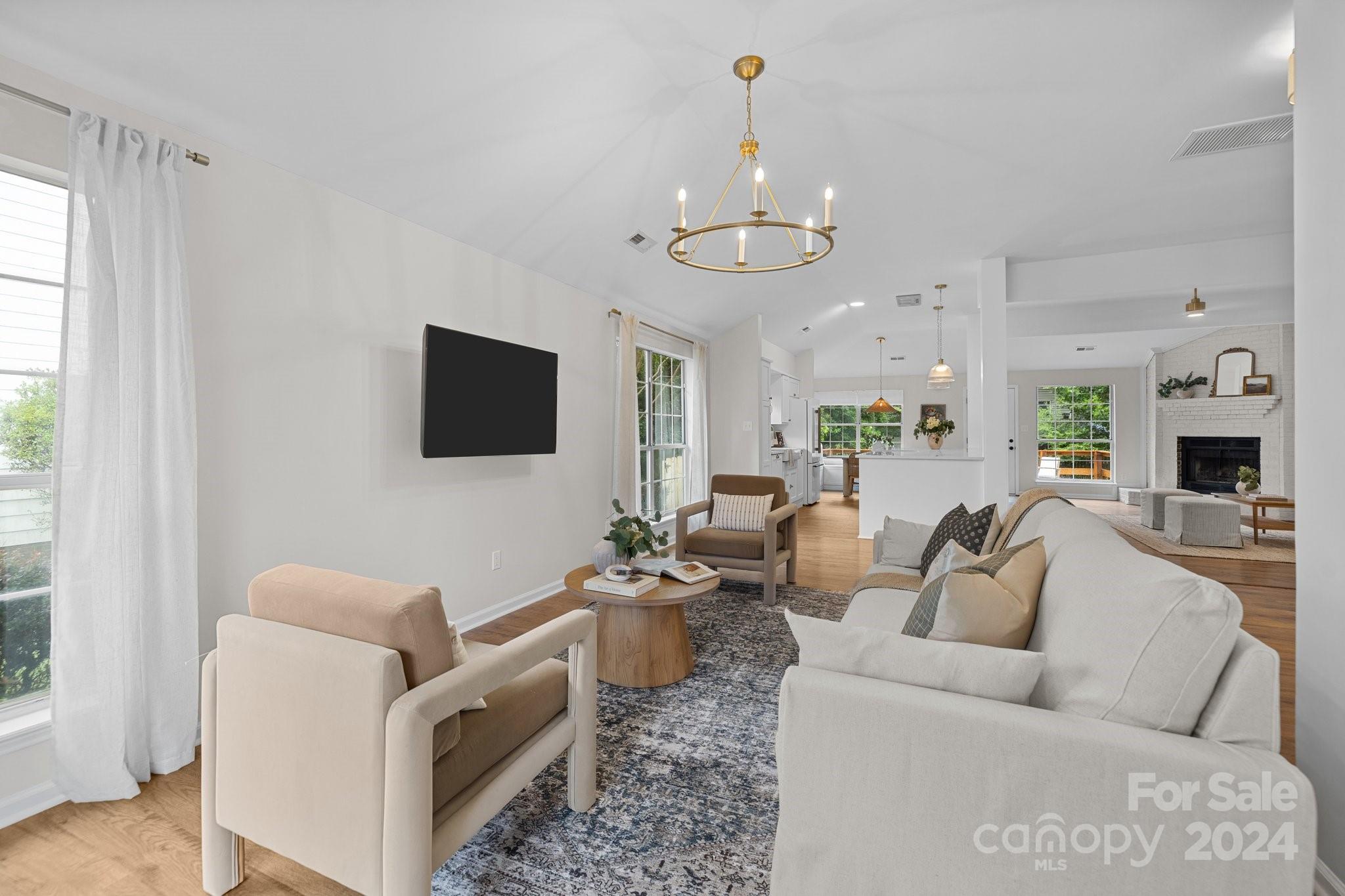 10527 Fairway Ridge Road Charlotte, NC 28277 - Photo 8 of 45 a living room with furniture a ceiling fan and a flat screen tv