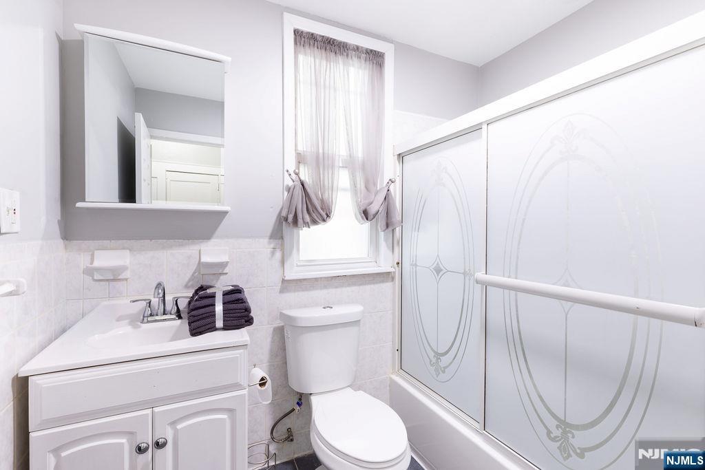 40-42 Harding Terrace Newark, NJ 07112 - Photo 11 of 15 a bathroom with a sink a toilet and a mirror
