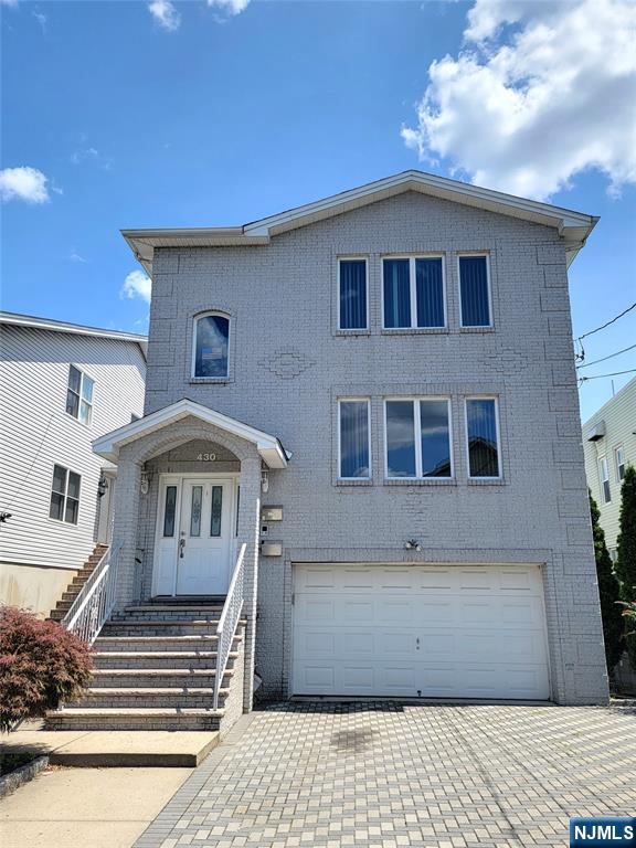 430 Elm Street, Unit 2 Kearny, NJ 07032 - Photo 1 of 14 a front view of a house with a yard