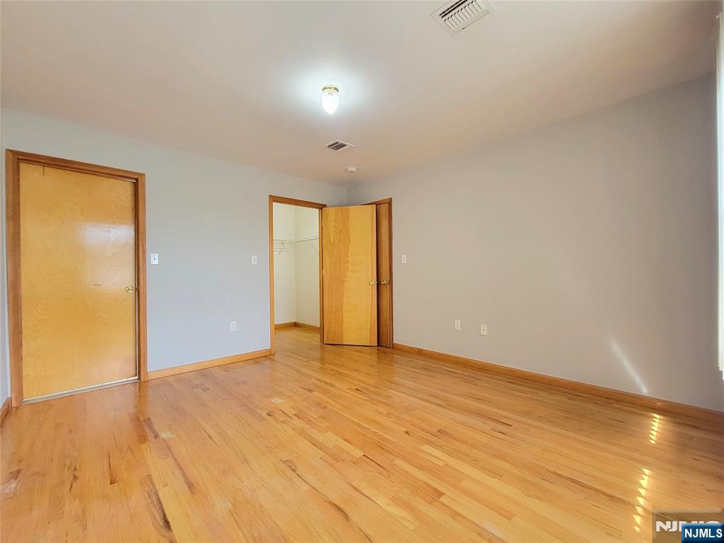 430 Elm Street, Unit 2 Kearny, NJ 07032 - Photo 12 of 14 a view of an empty room with wooden floor and a window