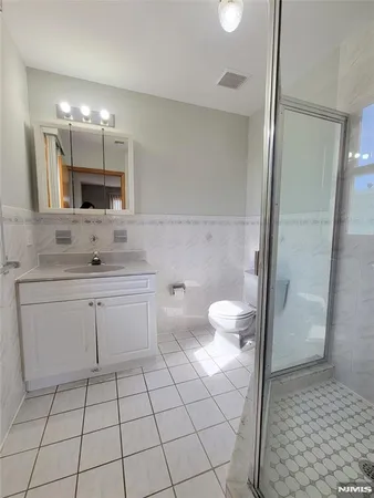 a bathroom with a double vanity sink mirror and toilet