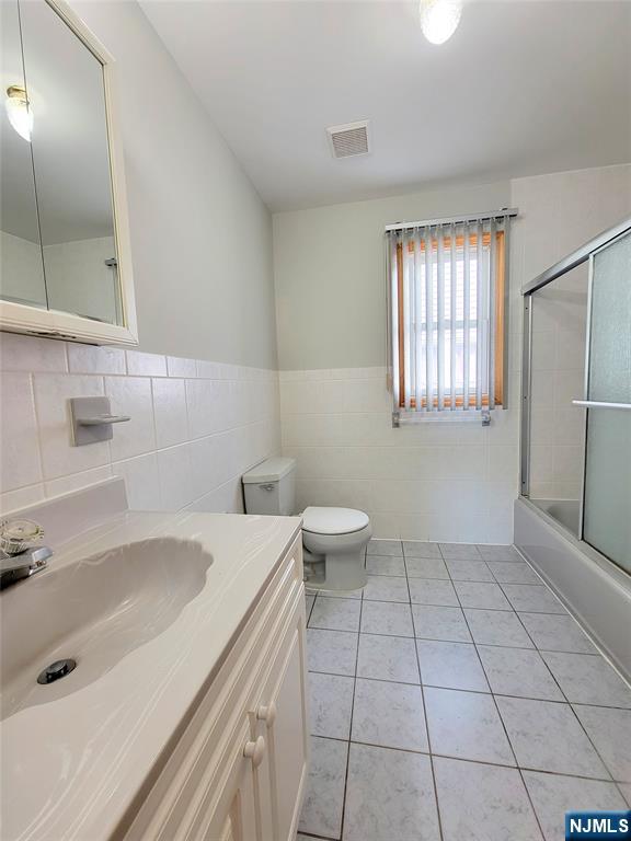 430 Elm Street, Unit 2 Kearny, NJ 07032 - Photo 9 of 14 a bathroom with a sink a toilet and shower