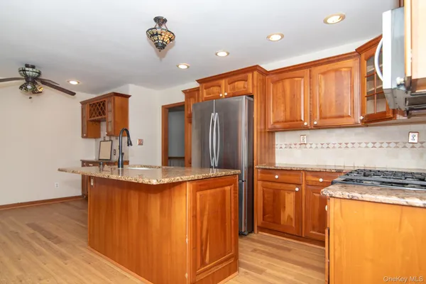 a kitchen with stainless steel appliances granite countertop a refrigerator and a stove top oven