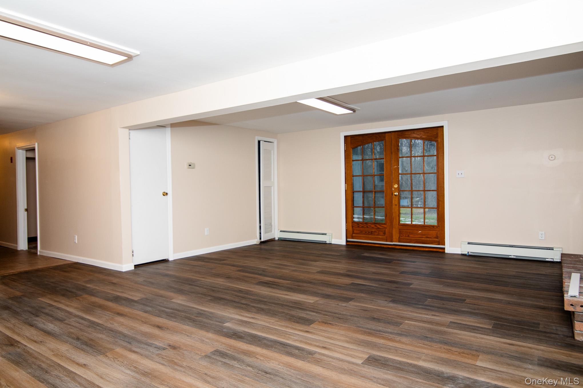172 Farmingdale Road Blooming Grove, NY 10918 - Photo 25 of 44 a view of an empty room with wooden floor and a window