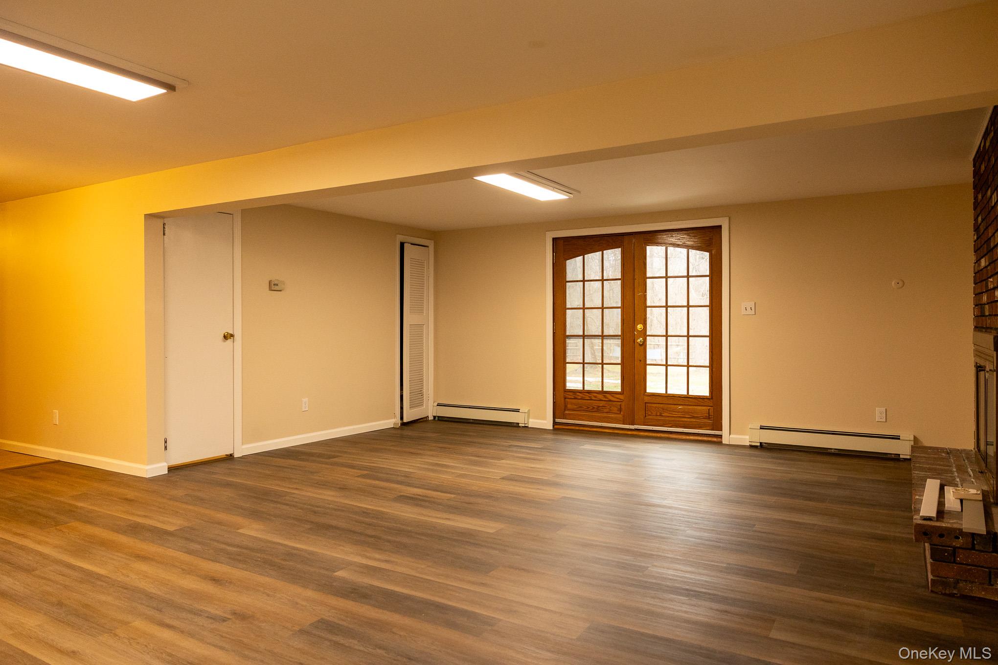 172 Farmingdale Road Blooming Grove, NY 10918 - Photo 29 of 44 a view of an empty room with wooden floor and a window