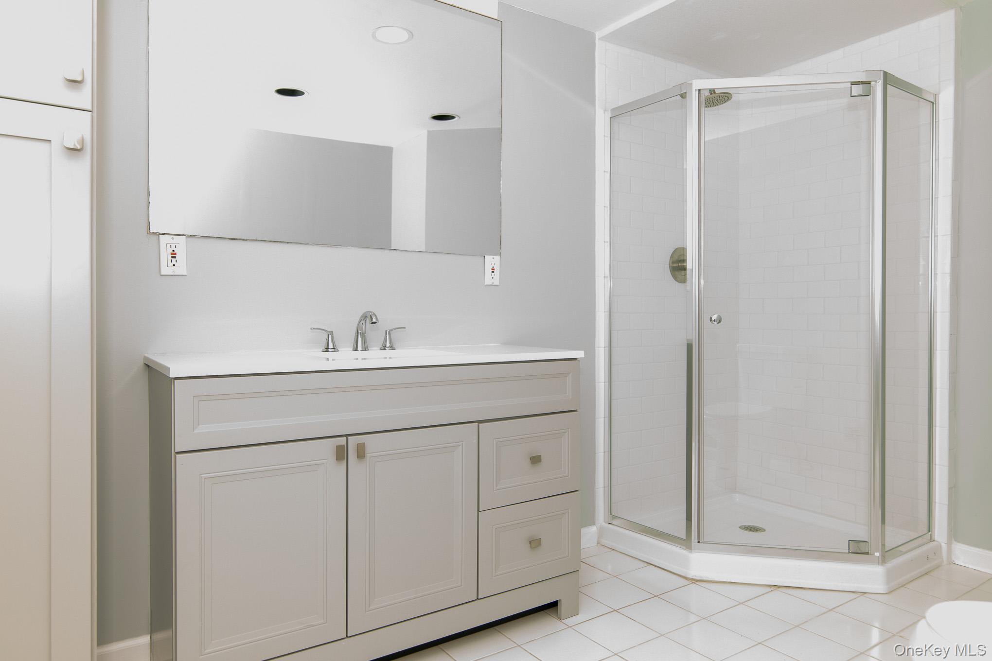 172 Farmingdale Road Blooming Grove, NY 10918 - Photo 31 of 44 a bathroom with a shower sink and mirror