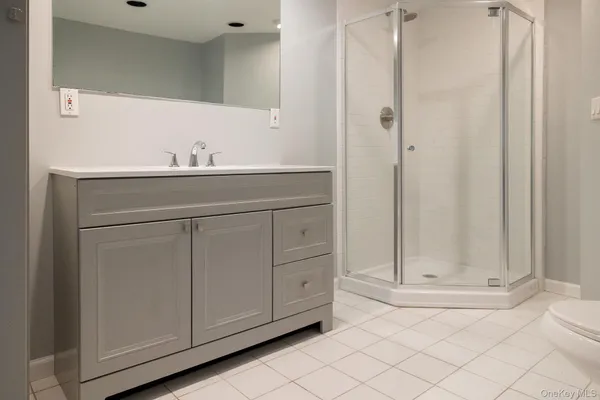 a bathroom with a sink vanity and mirror
