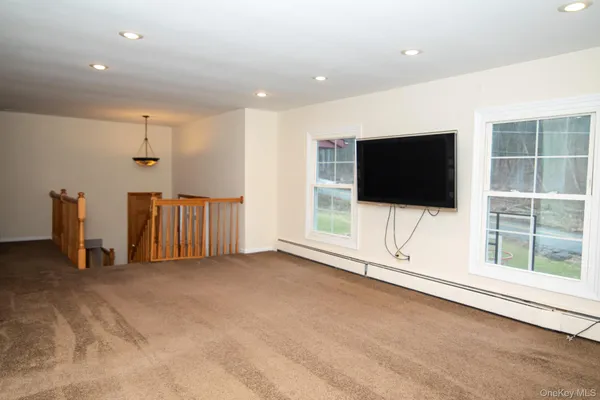 a view of a livingroom with an empty space and a flat screen tv