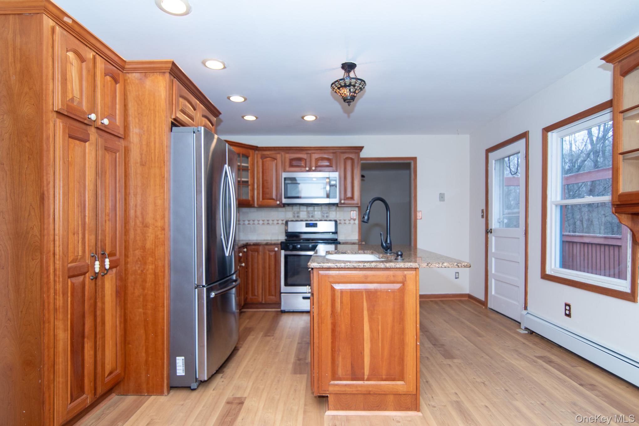 172 Farmingdale Road Blooming Grove, NY 10918 - Photo 7 of 44 a kitchen with stainless steel appliances granite countertop a refrigerator and a stove top oven