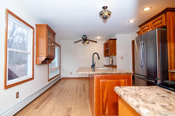 a kitchen view with wooden floor and window