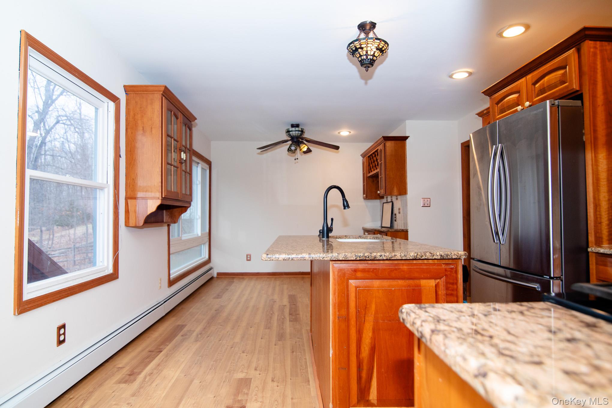 172 Farmingdale Road Blooming Grove, NY 10918 - Photo 10 of 44 a kitchen view with wooden floor and window